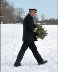  ?? PETE BANNAN – DIGITAL FIRST MEDIA ?? Retired Navy Capt. Alan Scherer places a wreath honoring the Navy at the mass grave at the Paoli Battlefiel­d Memorial Grounds.