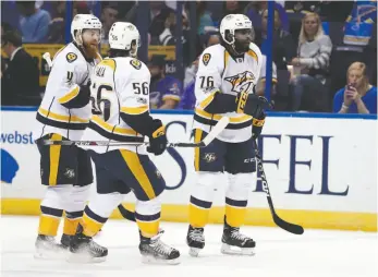  ?? AP PHOTO ?? Nashville Predators players Ryan Ellis, Kevin Fiala and P.K. Subban celebrate after Colin Wilson, not pictured, scored during the first period in Game 1 against the St. Louis Blues on Wednesday in St. Louis.