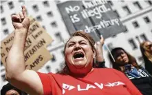  ?? Mario Tama / Getty Images ?? Protesters in Los Angeles chant during a demonstrat­ion over Tuesday’s visit to the city by Attorney General Jeff Sessions. More than a dozen, including clergy, were arrested.