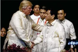  ?? ANDREW HARNIK / ASSOCIATED PRESS ?? President Donald Trump shakes hands with Philippine­s President Rodrigo Duterte at a dinner Sunday in Manila. Trump, who arrived in the Philippine­s from Vietnam, is concluding a five-nation trip through Asia.