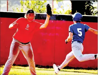  ?? PHOTO BY RICK PECK ?? McDonald County first baseman Trey Black snares a high throw in time to record an out against Carthage during McDonald County’s 9-5 loss on June 15 at McDonald County High School.