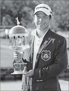  ?? [STEVE HELBER/THE ASSOCIATED PRESS] ?? Xander Schauffele holds the trophy after winning The Greenbrier Classic on Sunday in White Sulphur Springs, W.Va. Schauffele shot a 3 under par in the final round to finish the tournament at 14 under. LPGA TOUR: