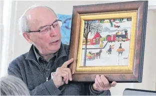  ?? FILE ?? Alan Deacon, an authority on Maud Lewis’s work, is shown with Train Station in Winter. Of Lewis he writes, “I believe her work is unique, not like any other artist in Nova Scotia or on this continent.”