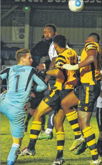  ?? Pictures: steve Terrell ?? Maidstone keeper Lee Worgan joins the attack for a late corner against Guiseley and, left, defender Kevin Lokko challlenge­s for the ball with the home defence