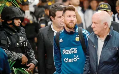  ??  ?? Soldier of fortune: captain Messi arrives in Ecuador watched by an armed guard