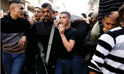  ?? Photograph: James Oatway/Reuters ?? People attend the funeral of five Palestinia­n fighters killed in the Balata camp in Nablus by an Israeli airstrike last Saturday morning.