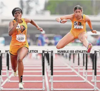  ?? Jason Fochtman / Staff photograph­er ?? Fort Bend Marshall’s Desirae Roberts, right, and Tairah Johnson finished second and first in the Class 5A girls 100-meter hurdles at the regional meet. Johnson is the defending state champion.