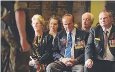  ??  ?? ABOVE: The Geelong Remembranc­e Day Service. LEFT: Lexie, Scarlett and Cadet Johanneson. RIGHT: Riley Simpson of the 32 Army Cadet Unit, which formed the Catafalque party.