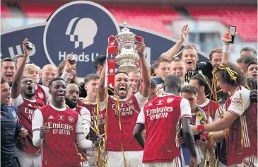  ?? AFP ?? Arsenal’s Pierre-Emerick Aubameyang holds the FA Cup trophy as the Gunners celebrate their final win over Chelsea at Wembley Stadium in London.