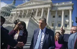  ?? J. SCOTT APPLEWHITE — THE ASSOCIATED PRESS ?? Sen. Joe Manchin, D-W.Va., is surrounded by reporters outside the Capitol in Washington on Wednesday.