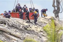  ?? AL DIAZ/MIAMI HERALD VIA AP ?? The South Florida Urban Search and Rescue team looks for survivors Saturday at the Champlain Towers South site in Surfside, Fla. Questions are rising about a 2018 engineerin­g report on the building.