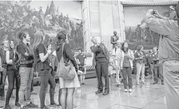  ?? Brendan Smialowski / AFP/Getty Images ?? Tourists listen to a tour guide speak in the Rotunda of the U.S. Capitol Building in Washington, D.C.