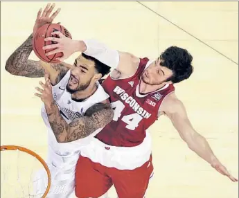 ?? David J. Phillip
Associated Press ?? WISCONSIN All-American Frank Kaminsky blocks a shot by Kentucky’s Willie Cauley-Stein in second half. Kaminsky finished with 20 points and 11 rebounds for the 36-3 Badgers; the Wildcats finished 38-1.