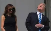  ?? NICHOLAS KAMM/AFP/GETTY IMAGES ?? U.S. President Donald Trump, despite warning, watches bare-eyed with wife Melania at the White House.