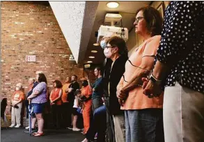  ?? Emily DiSalvo / Hearst Connecticu­t Media ?? South Windsor residents listen to local leaders discuss gun violence prevention at the Wear Orange rally on June 2. South Windsor officials have proposed an ordinance to ban the open carry of firearms in municipal buildings.