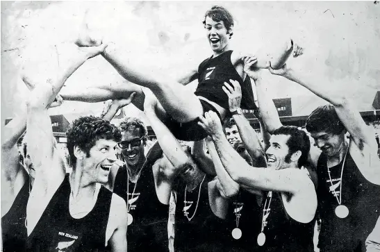  ?? ?? New Zealand’s Olympic gold medal winning 1972 Munich Olympics rowing eight celebrate after the medal ceremony by preparing to throw cox Simon Dickie into the water.