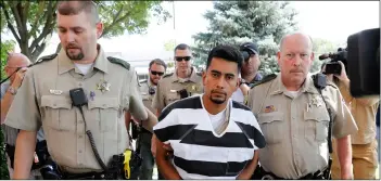  ?? AP PhoTo/ChArlIe neIBergAll ?? Cristhian Bahena rivera is escorted into the Poweshiek County Courthouse for his initial court appearance, on Wednesday.