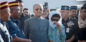  ?? — Bernama ?? Sombre affair: Dr Mahathir and Dr Siti Hasmah paying their last respects to Muhammad Adib at the Airod facility in Subang.