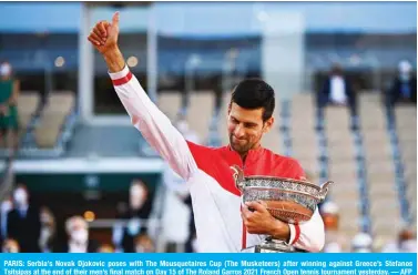  ??  ?? PARIS: Serbia’s Novak Djokovic poses with The Mousquetai­res Cup (The Musketeers) after winning against Greece’s Stefanos Tsitsipas at the end of their men’s final match on Day 15 of The Roland Garros 2021 French Open tennis tournament yesterday. — AFP