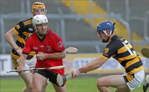  ??  ?? Rory Higgins of Rathnure tries to make life difficult for Des Mythen (Oulart-The Ballagh).