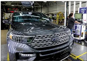  ?? AP ?? Ford Motor Co. employees work on an assembly line in June for Explorer SUVs at a Chicago plant. The Federal Reserve says U.S. factory output rose 0.5% in August after a drop in July, but there were fewer new orders, a sign that production will fall in the coming months.