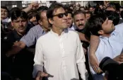  ?? — AP ?? Opposition politician Imran Khan leaves Parliament after a Parliament session in Islamabad on Thursday.