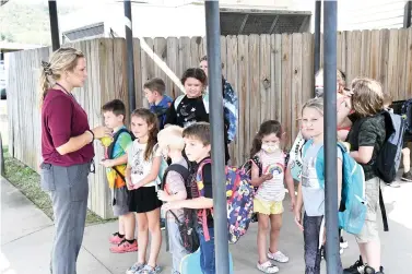  ?? The Sentinel-Record/Tanner Newton ?? ■ Teacher Rebekah Dixon stands with Cutter Morning Star students as they wait to be picked up on Wednesday.
