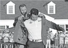  ?? ROB SCHUMACHER/USA TODAY SPORTS ?? Defending champion Dustin Johnson presents Hideki Matsuyama with the green jacket after he won the Masters by one shot.