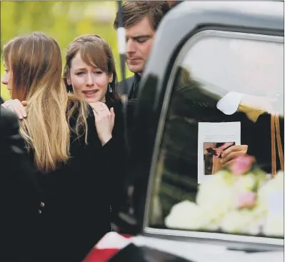  ?? PICTURE: GETTY IMAGES ?? EMOTIONAL DAY: Ann Maguire’s daughter Emma, second left, and husband Don, right, embrace mourners following the funeral.