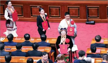  ?? YIN BOGU / XINHUA ?? Role models in China’s poverty alleviatio­n fight are presented with medals, certificat­es and plaques at a gathering at the Great Hall of the People in Beijing on Feb 25.