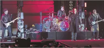  ?? AP PHOTOS, ABOVE AND RIGHT ?? ROCKIN’ OUT: Members of U2 — the Edge, Larry Mullen Jr., Bono (and at right) and Adam Clayton — play an outdoor show in London’s Trafalgar Square earlier this month. The band will release its latest album, ‘Songs of Experience,’ below right, tomorrow.