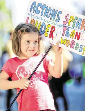  ?? PHOTO: GERRY MOONEY ?? Worthy cause: Claire McGrath (5) from Naas, Co Kildare, holds up her placard at the climate change protest in Merrion Square, Dublin.