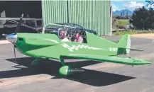  ??  ?? Ian Sinnott and a friend in his distinctiv­e green plane.