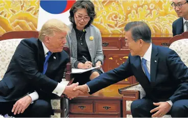  ?? /Reuters ?? Building bridges: US President Donald Trump, left, and South Korea President Moon Jae-in shake hands at the presidenti­al Blue House in Seoul on Tuesday. Trump called for a ‘free, fair, and reciprocal’ trade deal with his security ally.