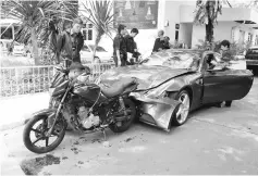  ?? — Reuters photo ?? File photo show policemen examine a damaged Ferrari at the home of the late Red Bull founder Chaleo Yoovidhaya in Bangkok, Thailand.