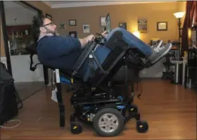  ?? PHOTOS BY GENE WALSH - MEDIANEWS GROUP ?? James Myers works on his computer in his wheelchair that is tilted to relieve pressure on his spine February 6, 2019.