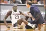  ?? Jessica Hill / Associated Press ?? UConn’s Akok Akok reacts while tended to by head trainer James Doran against Memphis in February.