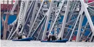  ?? Photo: AP ?? Police boats work near the collapsed bridge.