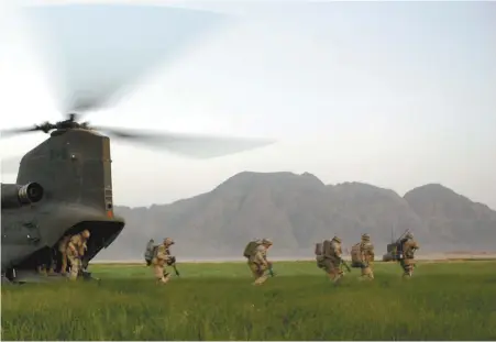  ?? MURRAY BREWSTER LA PRESSE CANADIENNE ?? Des soldats canadiens descendent de l’arrière d’un hélicoptèr­e CH-47D Chinook dans le cadre d’un balayage de villages au sud-ouest de la ville de Kandahar, le 26 mars 2010, à Khenjakak, en Afghanista­n. Une force de 1000 soldats a mené une opération de six jours pour découvrir que des villageois avaient déjà expulsé les talibans de la région.