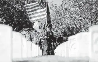  ?? Joshua Trujjillo / Staff photograph­er ?? A joint color guard of members from the Army, Air Force, Coast Guard, Navy and Marines marches through the Fort Sam Houston National Cemetery. Memorial Day’s origins are in the Civil War.