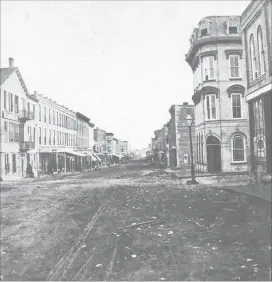  ?? PICASA SPECIAL TO THE EXAMINER ?? George Street looking south from Brock Street, c. 1870. Notice the Commercial Hotel building on the left and the line of buildings on the east side of George. The Cox building on the right provides the first sign of the four-storey mansard roof building that would in the next decade fill the gap just beyond. The gas lamp lighting along George Street was a first for Canada.