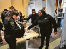  ?? Brian A. Pounds ?? Students have their backpacks searched and pass through metal detectors at a school in Bridgeport, Conn. The Santa Fe school board is scheduled to vote today on several safety measures.