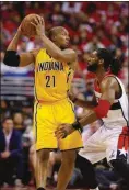  ?? Alex Brandon / AP ?? Indiana Pacers forward David West (21) protects the ball from Washington Wizards forward Nene from Brazil (42) during the first half Thursday in Game 6 of the Eastern Conference semifinal playoffs in Washington.