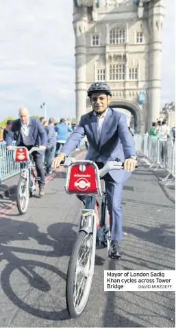  ?? DAVID MIRZOEFF ?? Mayor of London Sadiq Khan cycles across Tower Bridge