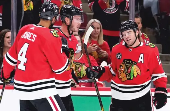  ?? NAM Y. HUH/AP ?? Blackhawks winger Alex DeBrincat (right), celebratin­g with defenseman Seth Jones and center Jonathan Toews, likely will receive more time on the penalty kill.