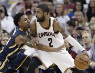  ?? TONY DEJAK — THE ASSOCIATED PRESS ?? Indiana Pacers’ Jeff Teague, left, reaches in as Cleveland Cavaliers’ Kyrie Irving drives to the basket in the second half in Game 1 of a first-round NBA basketball playoff series, Saturday in Cleveland.