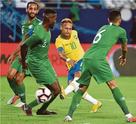  ?? AFP PIC) ?? Brazil’s Neymar (second from right) takes a shot at goal in a friendly against Saudi Arabia at the King Saud University Stadium in Riyadh on Friday.