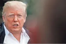  ?? JACQUELYN MARTIN/AP ?? President Donald Trump answers a question from a member of the media as he leaves the White House on Saturday, en route to see fire damage in California.