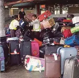  ??  ?? Workers attending to passengers’ baggage at the Kuala Lumpur Internatio­nal Airport yesterday.