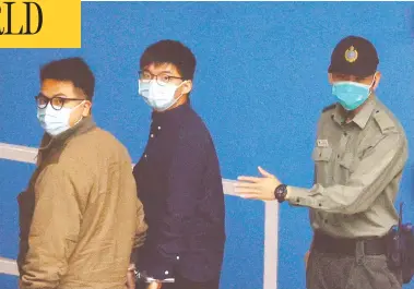  ?? TYRONE SIU/ REUTERS ?? Pro-democracy activists Ivan Lam, left, and Joshua Wong arrive at a Hong Kong maximum security institutio­n after pleading guilty on Monday to charges of inciting and organizing an “unauthoriz­ed assembly” in June 2019.